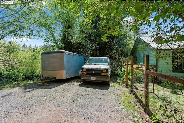 view of parking / parking lot with fence