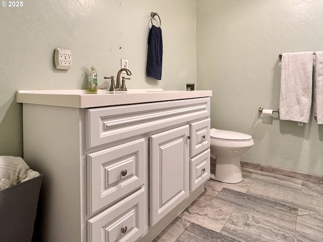 bathroom featuring toilet and vanity