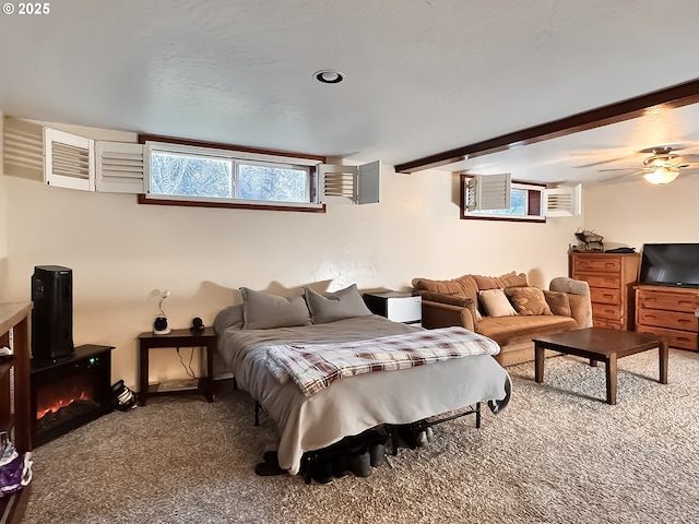 carpeted bedroom featuring beamed ceiling and a wall unit AC