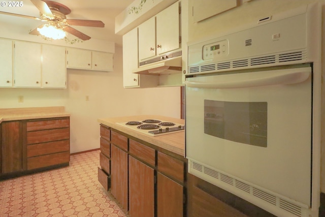 825 Seabreeze Ter, Coos Bay, OR 97420 - kitchen featuring under cabinet range hood, white appliances, a ceiling fan, light countertops, and light flooring