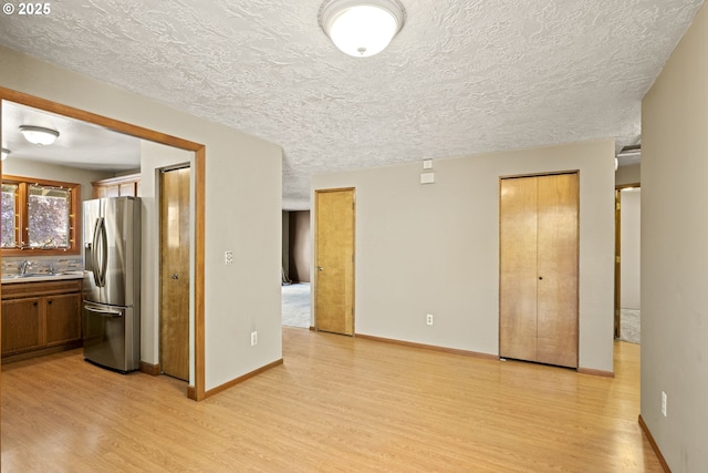 2301 SW 22nd St, Troutdale, OR 97060 - kitchen featuring stainless steel fridge, light wood-style floors, a textured ceiling, and light countertops