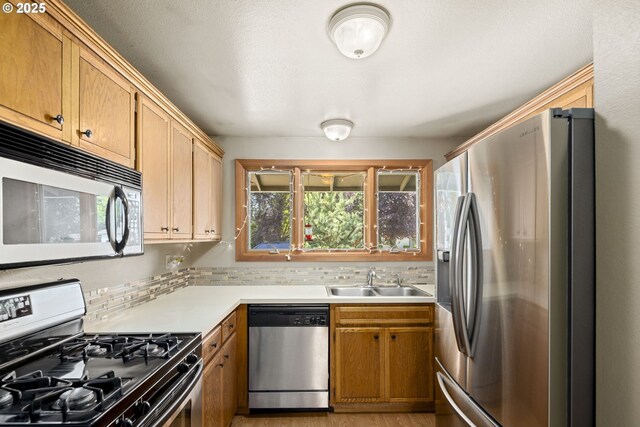 2301 SW 22nd St, Troutdale, OR 97060 - kitchen featuring appliances with stainless steel finishes, plenty of natural light, light countertops, and decorative backsplash