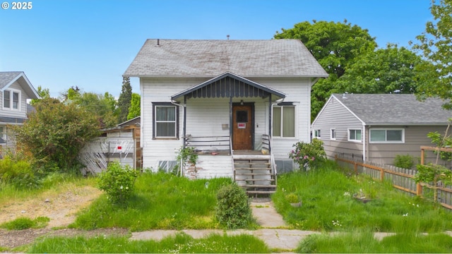 bungalow-style home featuring fence and covered porch