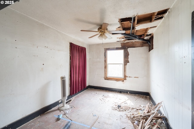 spare room with a ceiling fan and a textured ceiling