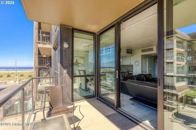 balcony with a water view and visible vents