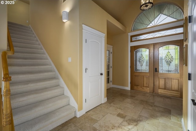 2567 SE Coriander, Grants Pass, OR 97527 - foyer entrance with stairway, stone tile floors, and lofted ceiling