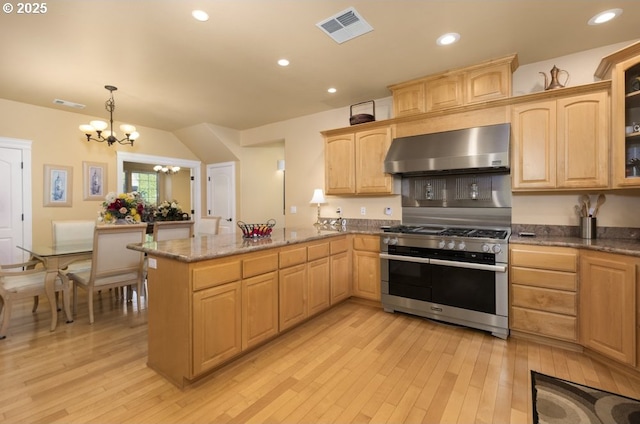 2567 SE Coriander, Grants Pass, OR 97527 - kitchen with wall chimney range hood, double oven range, light wood-style flooring, a chandelier, and recessed lighting