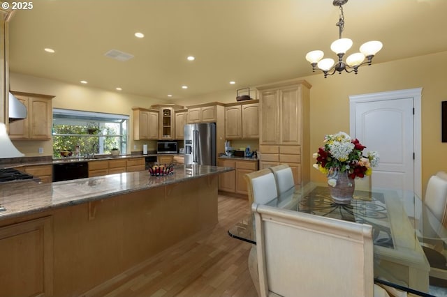 2567 SE Coriander, Grants Pass, OR 97527 - kitchen with appliances with stainless steel finishes, a chandelier, light wood finished floors, a kitchen bar, and a peninsula