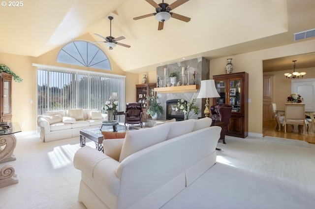 2567 SE Coriander, Grants Pass, OR 97527 - carpeted living room featuring a premium fireplace, high vaulted ceiling, a chandelier, and a ceiling fan