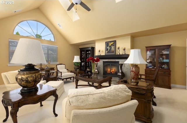 2567 SE Coriander, Grants Pass, OR 97527 - living room featuring lofted ceiling, a ceiling fan, a high end fireplace, light carpet, and a skylight