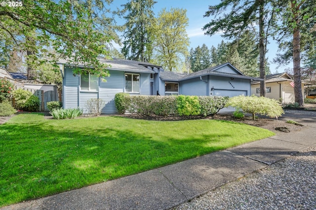 10145 SW Paulina Dr, Tualatin, OR 97062 - split level home featuring roof with shingles, a front lawn, fence, and an attached garage