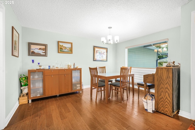10145 SW Paulina Dr, Tualatin, OR 97062 - dining space featuring baseboards, a chandelier, wood finished floors, and a textured ceiling