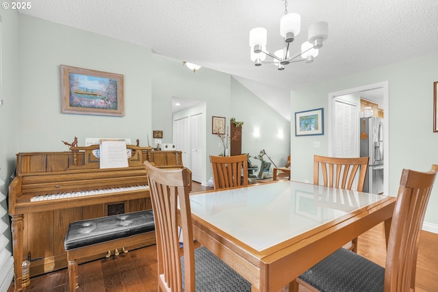 10145 SW Paulina Dr, Tualatin, OR 97062 - dining space featuring a textured ceiling, wood finished floors, and a notable chandelier