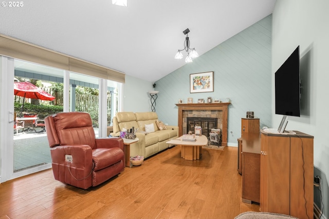 10145 SW Paulina Dr, Tualatin, OR 97062 - living area featuring light wood-style flooring, a tile fireplace, and vaulted ceiling
