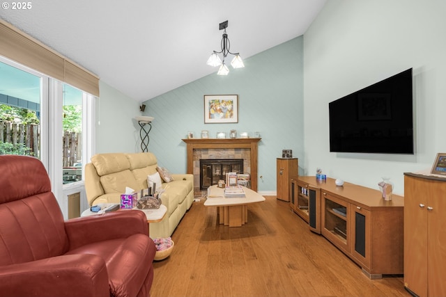 10145 SW Paulina Dr, Tualatin, OR 97062 - living room featuring a tiled fireplace, light wood-type flooring, and vaulted ceiling