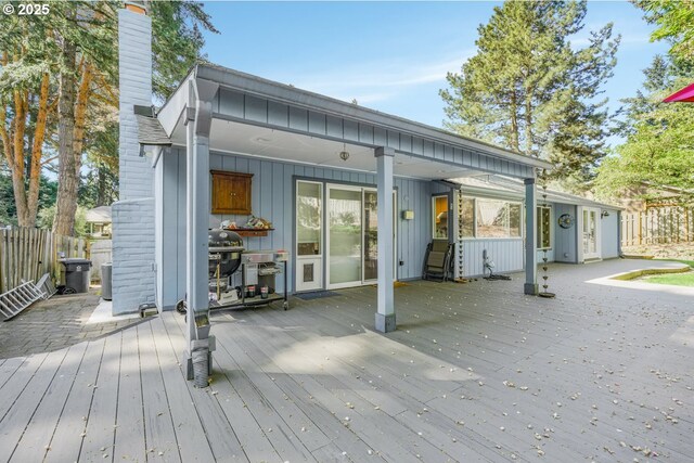 10145 SW Paulina Dr, Tualatin, OR 97062 - rear view of property with board and batten siding, fence, a wooden deck, and a chimney