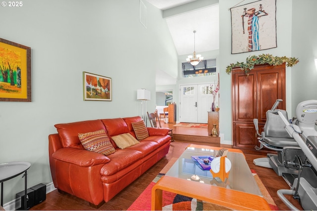 10145 SW Paulina Dr, Tualatin, OR 97062 - living room with visible vents, baseboards, an inviting chandelier, wood finished floors, and high vaulted ceiling