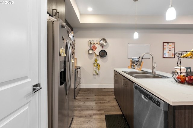 5394 SE 136th Ave, Portland, OR 97236 - kitchen featuring stainless steel appliances, dark wood-style floors, dark brown cabinetry, light countertops, and pendant lighting