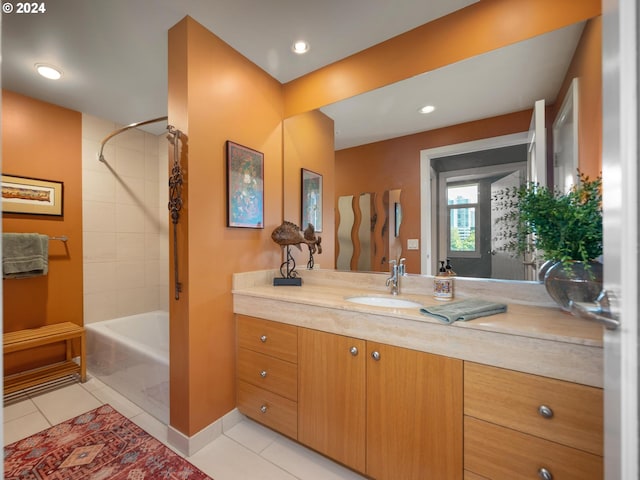 bathroom with tile patterned floors, vanity, and tiled shower / bath combo