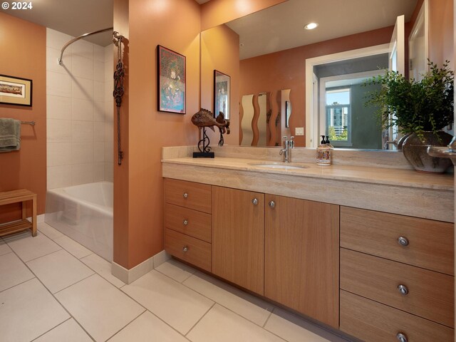 bathroom with tiled shower / bath, vanity, and tile patterned floors