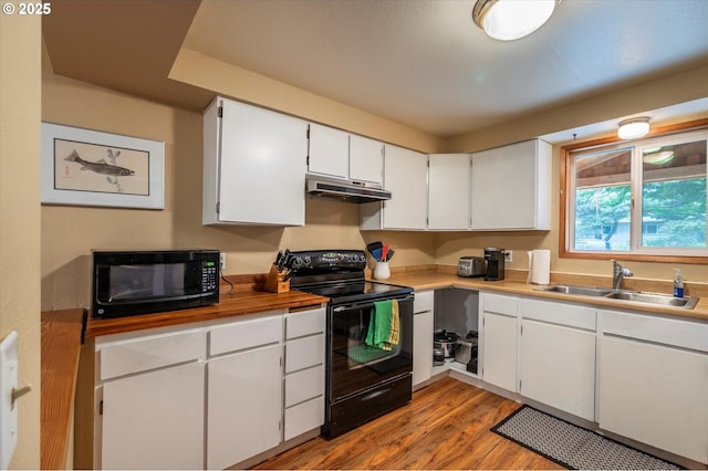 1145 Newport Ave SW, Bandon, OR 97411 - kitchen featuring black appliances, under cabinet range hood, light wood-style flooring, white cabinetry, and light countertops