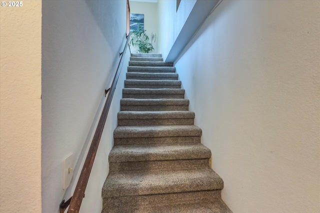 1145 Newport Ave SW, Bandon, OR 97411 - stairway featuring a high ceiling and a textured wall