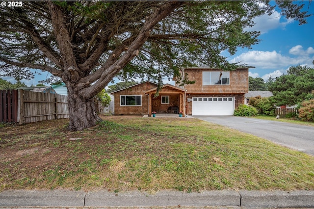 1145 Newport Ave SW, Bandon, OR 97411 - view of front of house featuring an attached garage and asphalt driveway
