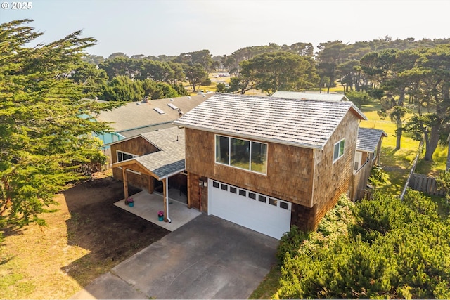 1145 Newport Ave SW, Bandon, OR 97411 - view of front of home featuring a garage and asphalt driveway