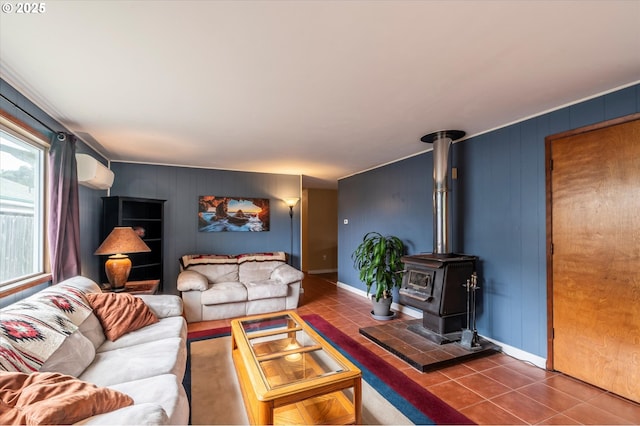 1145 Newport Ave SW, Bandon, OR 97411 - tiled living area with an AC wall unit and a wood stove