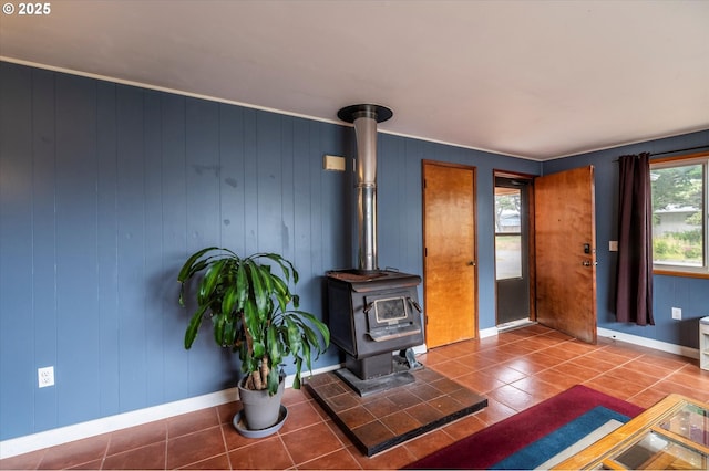 1145 Newport Ave SW, Bandon, OR 97411 - unfurnished living room with tile patterned flooring and a wood stove