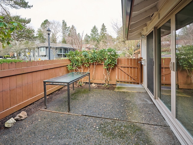 view of yard featuring a patio area, a gate, and fence