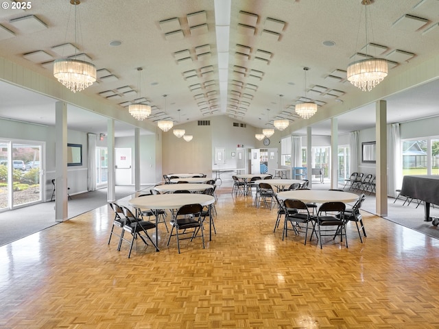 dining area featuring a textured ceiling, visible vents, and a notable chandelier