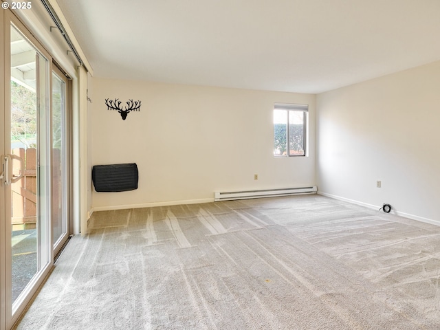 carpeted empty room with a baseboard radiator and baseboards