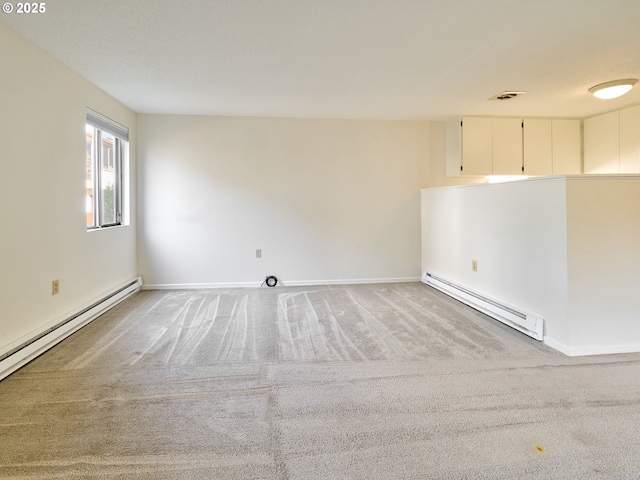 unfurnished room with baseboards, baseboard heating, and light colored carpet