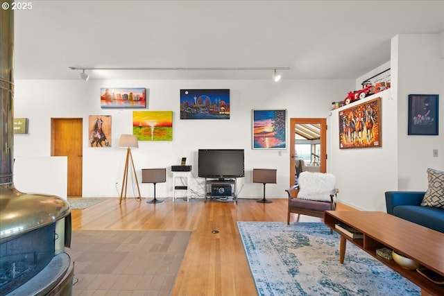 living area featuring rail lighting and wood finished floors