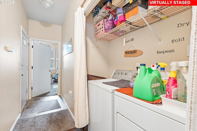 clothes washing area featuring carpet flooring, washing machine and dryer, laundry area, and baseboards