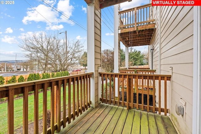 wooden terrace with a yard