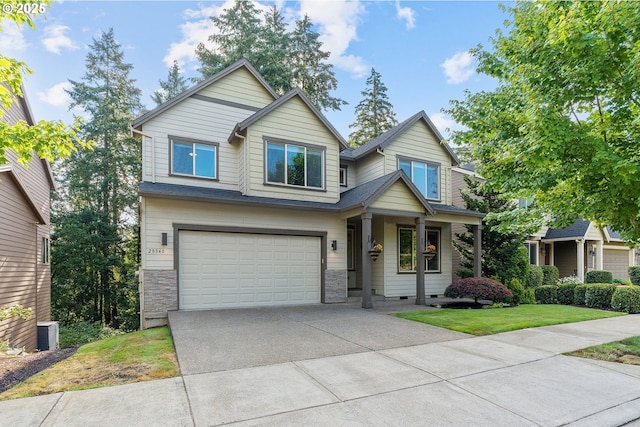 craftsman inspired home with a front lawn and a garage