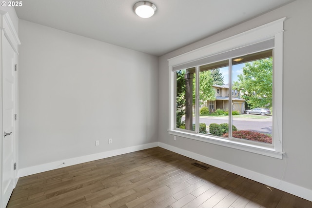 unfurnished room featuring hardwood / wood-style floors