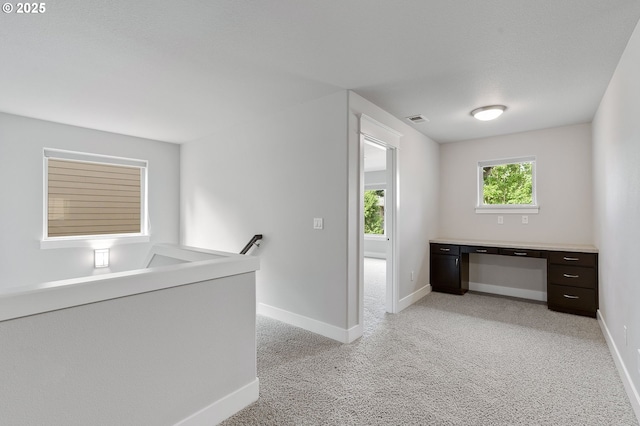 28340 SW Mcgraw Ave, Wilsonville, OR 97070 - corridor featuring baseboards, a desk, light carpet, and an upstairs landing