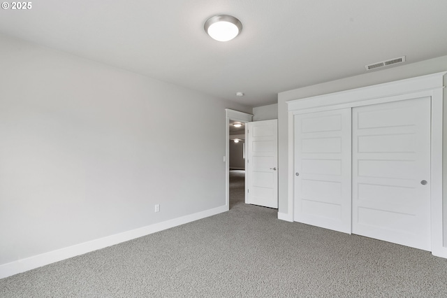 unfurnished bedroom featuring carpet flooring and a closet