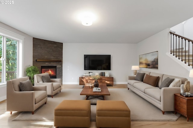 living room with a fireplace and light hardwood / wood-style floors