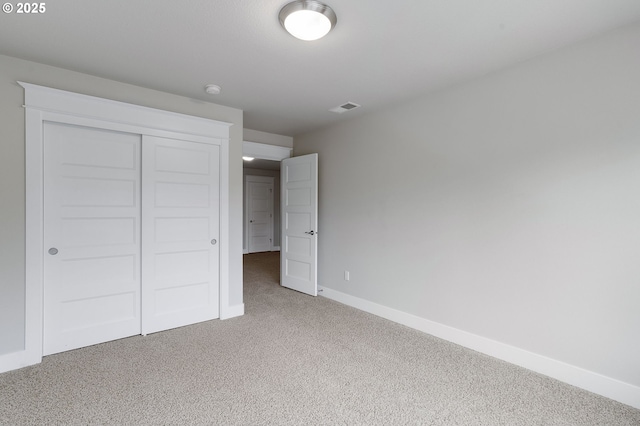 unfurnished bedroom featuring carpet floors and a closet