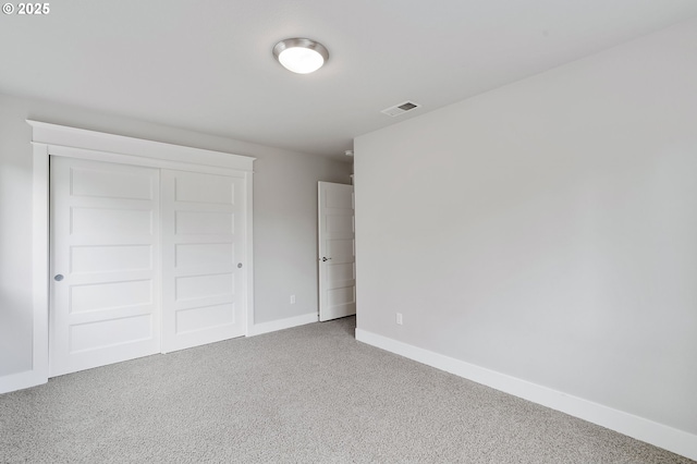 unfurnished bedroom featuring carpet floors and a closet