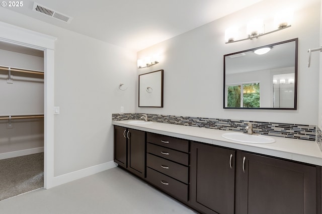 bathroom with decorative backsplash and vanity