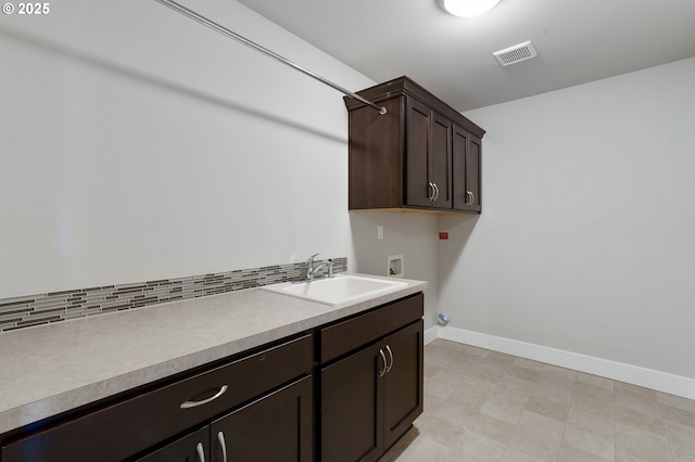 laundry room featuring cabinets, sink, and hookup for a washing machine