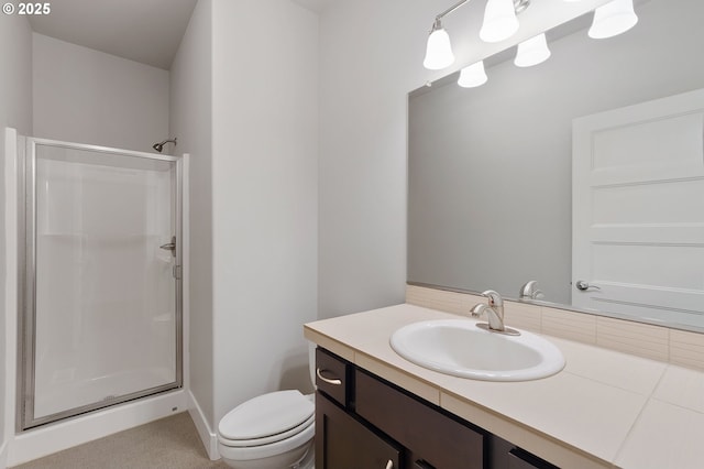 bathroom featuring vanity, toilet, and an enclosed shower