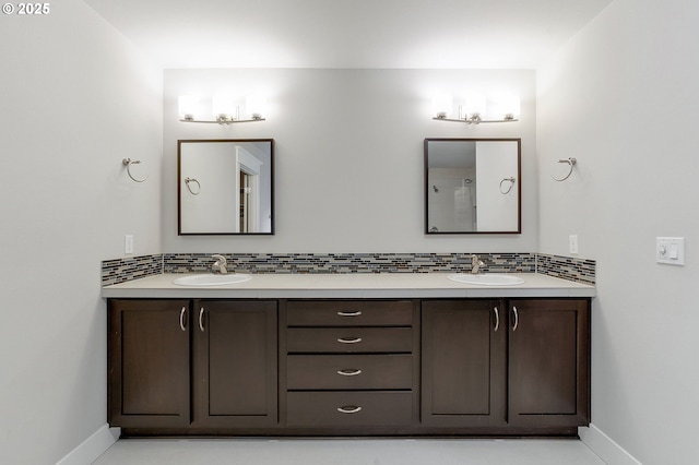 bathroom featuring tile patterned flooring, vanity, and tasteful backsplash