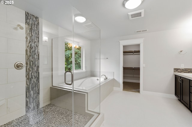28340 SW Mcgraw Ave, Wilsonville, OR 97070 - bathroom featuring a stall shower, vanity, a bath, a spacious closet, and baseboards