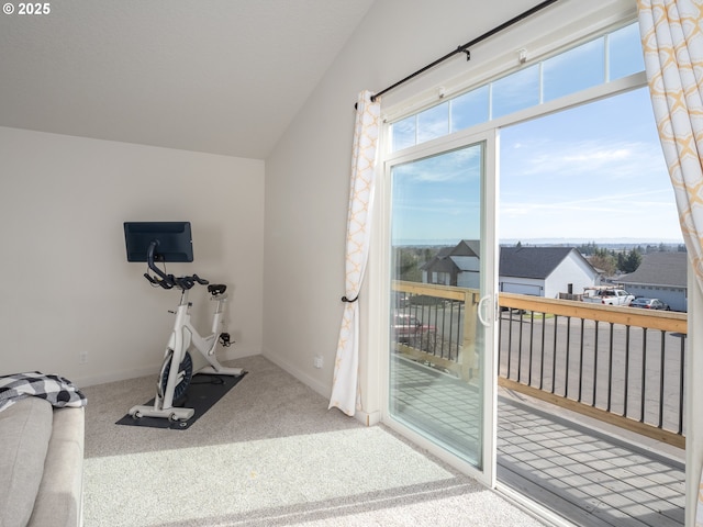 exercise area with carpet floors, lofted ceiling, and baseboards